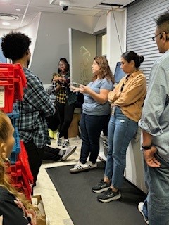 Pharmacy staff at the Callen-Lorde Chelsea location meet for their daily standup meeting in the back of the pharmacy